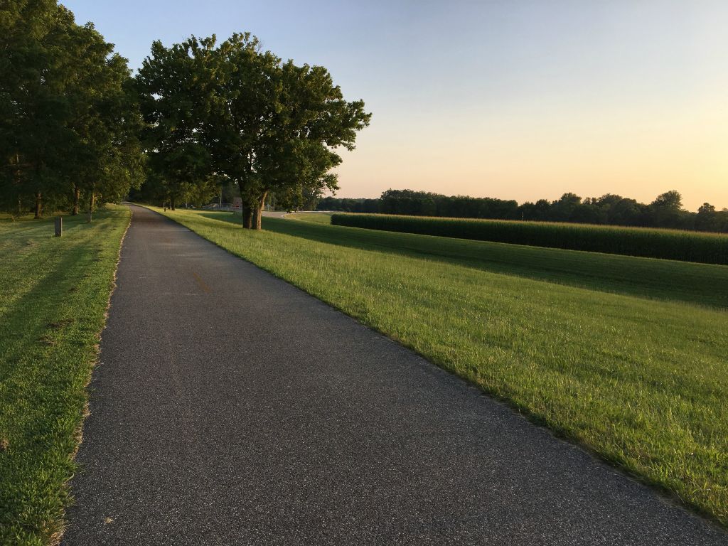 Nice paved trail with a neat corn field in the background